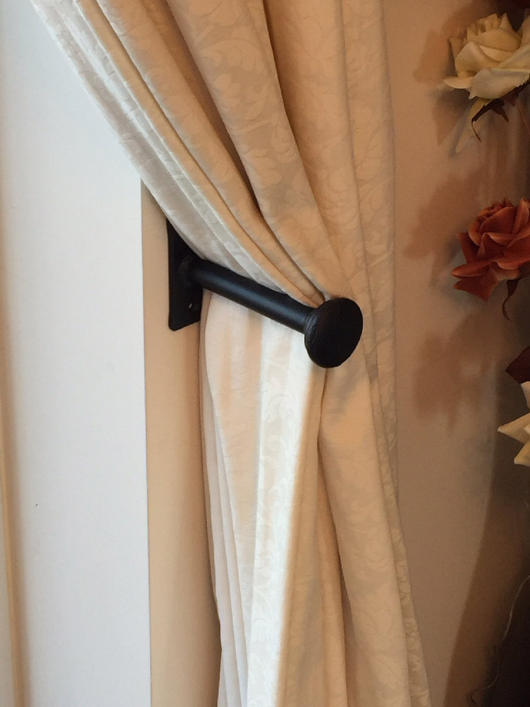 A Pair of Hand Forged Wrought Iron Holdbacks With Button Ends